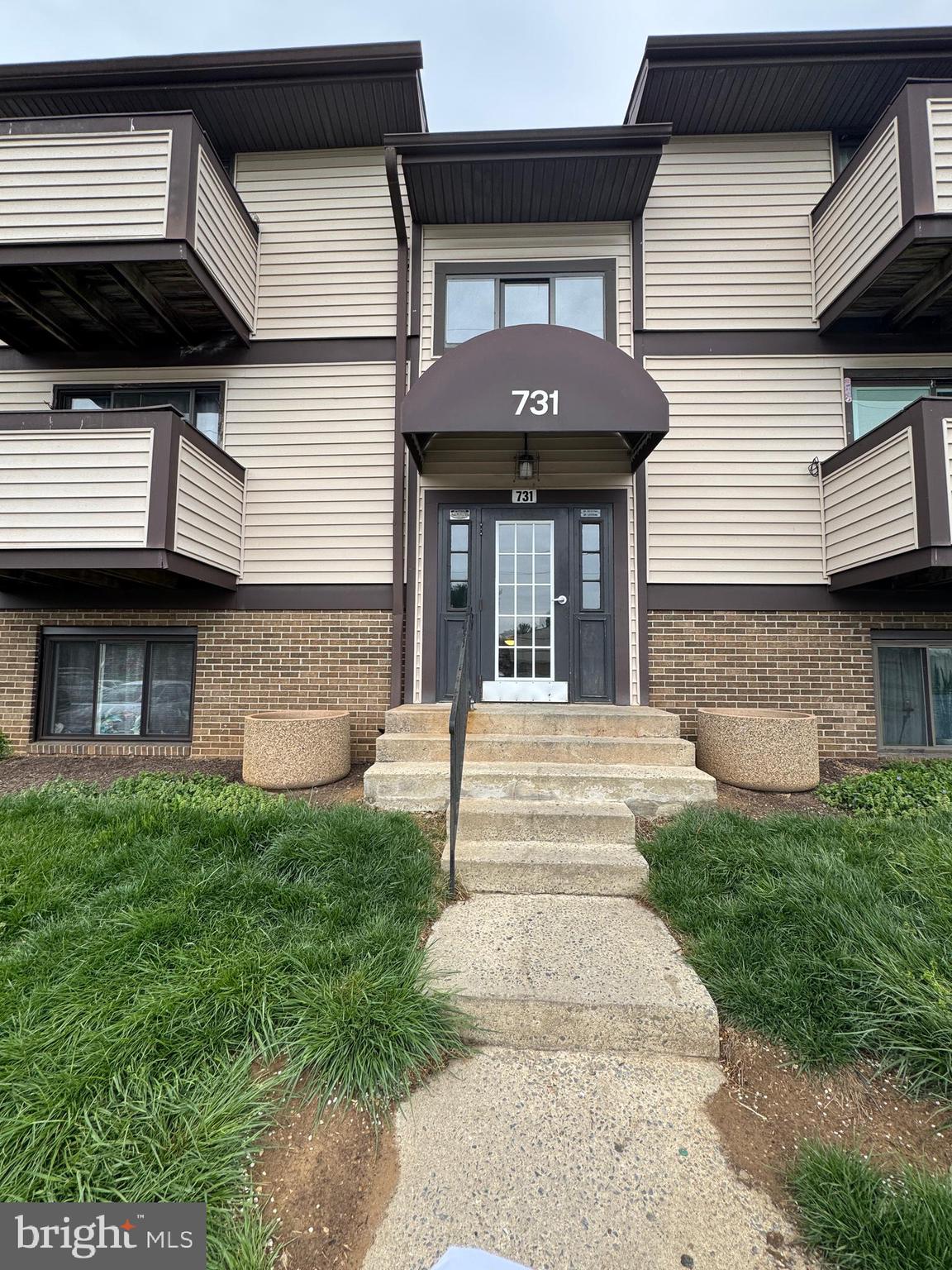 731 Heather Ridge Drive, Unit F Frederick, MD 21702 - Photo 2 of 7 a front view of a house with a garden