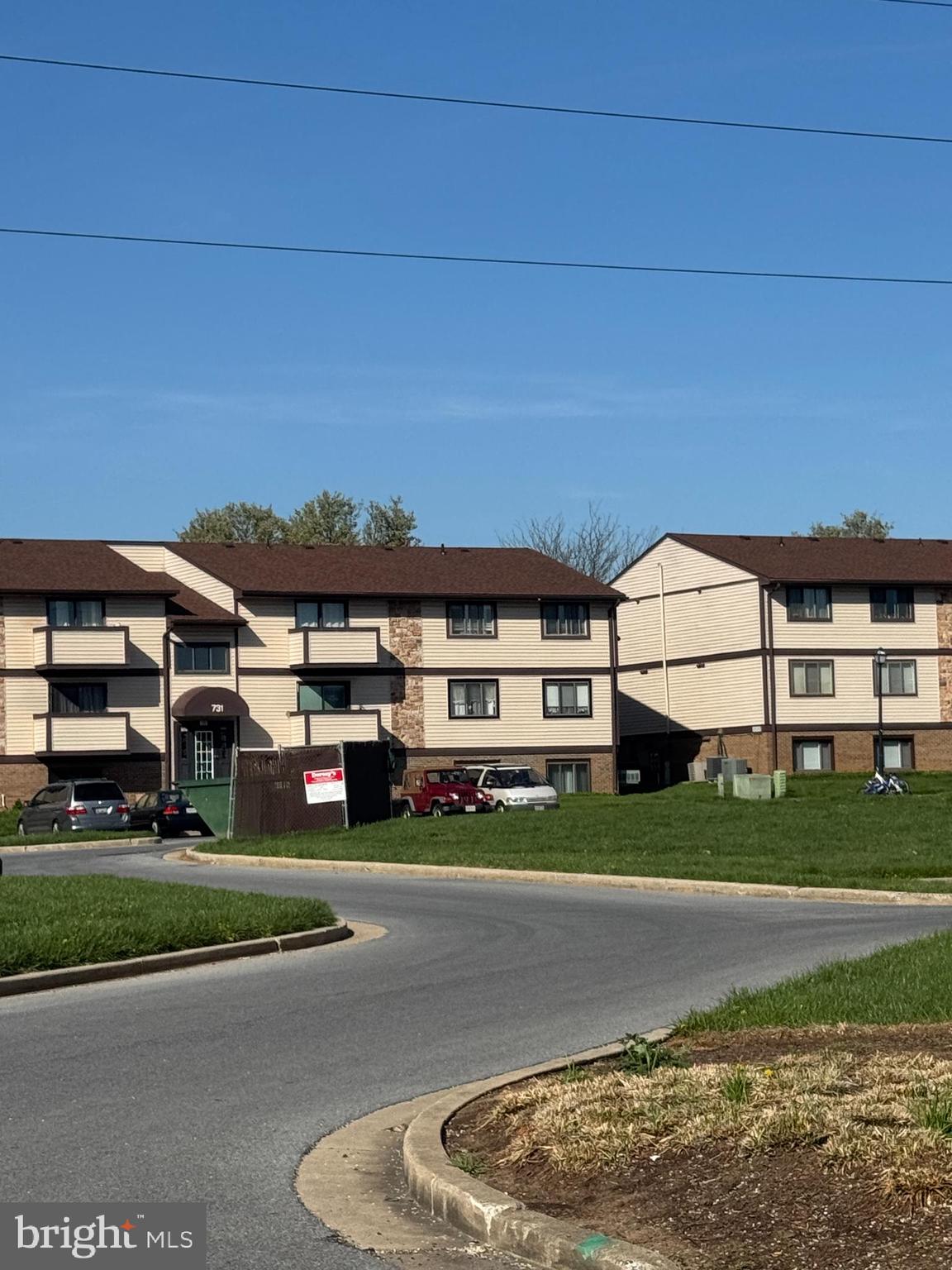 731 Heather Ridge Drive, Unit F Frederick, MD 21702 - Photo 4 of 7 a view of a white house with a big yard and potted plants