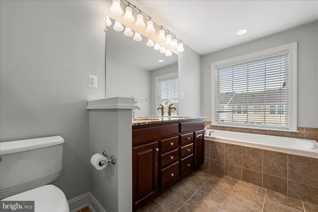 a bathroom with a toilet a sink and bathtub