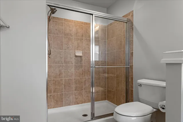 a bathroom with a toilet and a shower