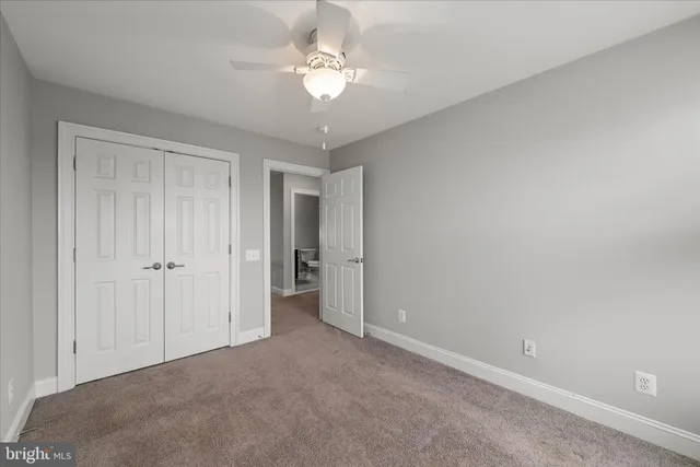a view of a room with a ceiling fan