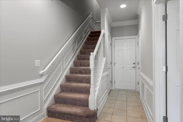 a view of a hallway to rooms and stairs