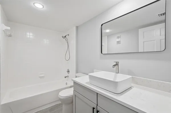 a bathroom with a sink a toilet and a bathtub
