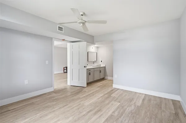 a view of a kitchen with a sink and a refrigerator