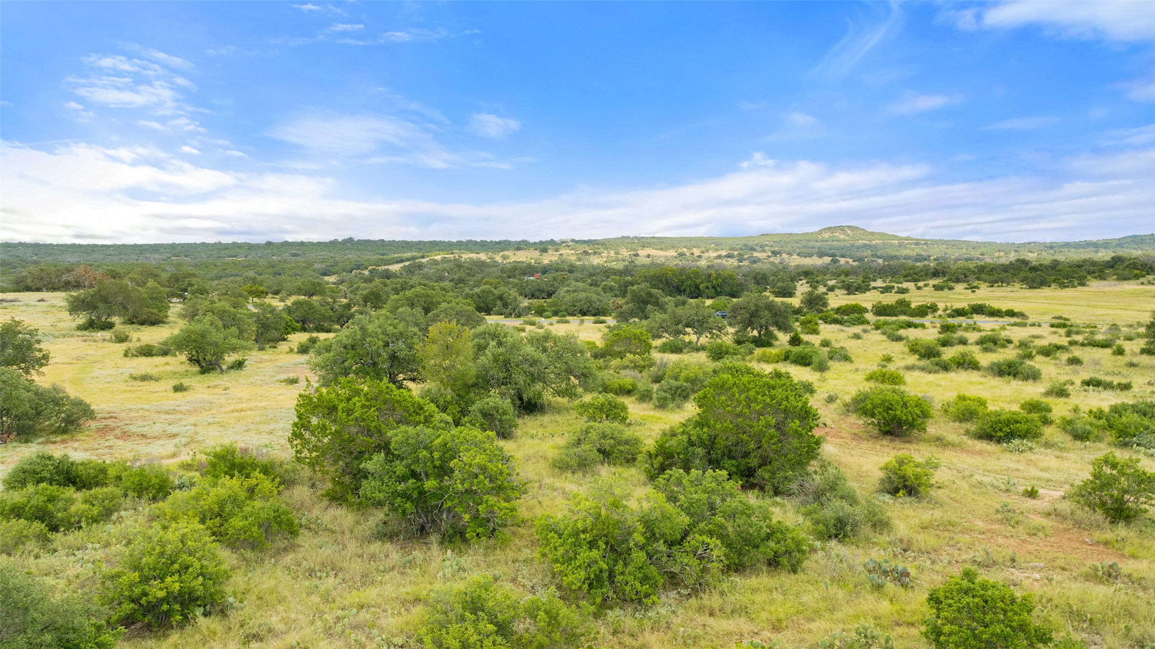 Lot 37 Vista Rdg Drive Round Mountain, TX 78663 - Photo 8 of 30 Aerial view of sparsely populated area featuring a mountainous background