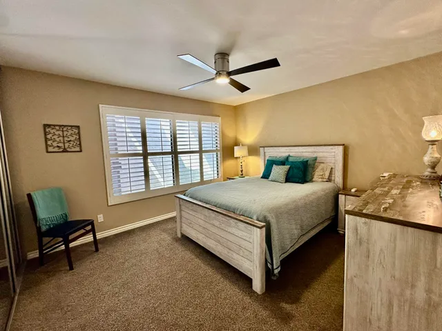 a bedroom with a bed chair and a window