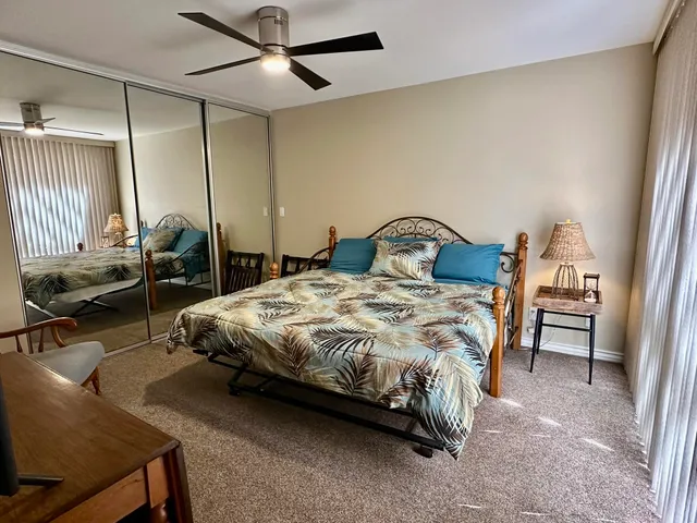 a bedroom with a bed a desk and chair