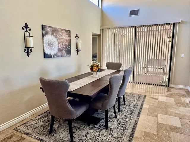 a dining room with furniture and wooden floor
