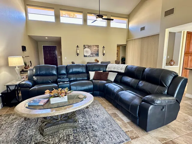 a living room with furniture and a chandelier