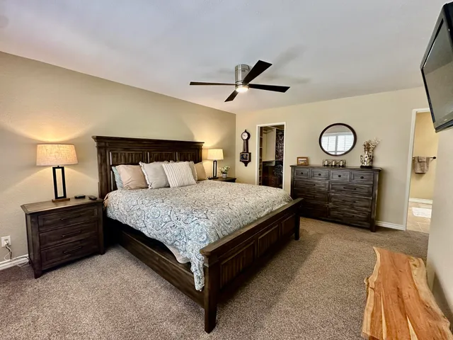 a bedroom with a bed and a lamp on table