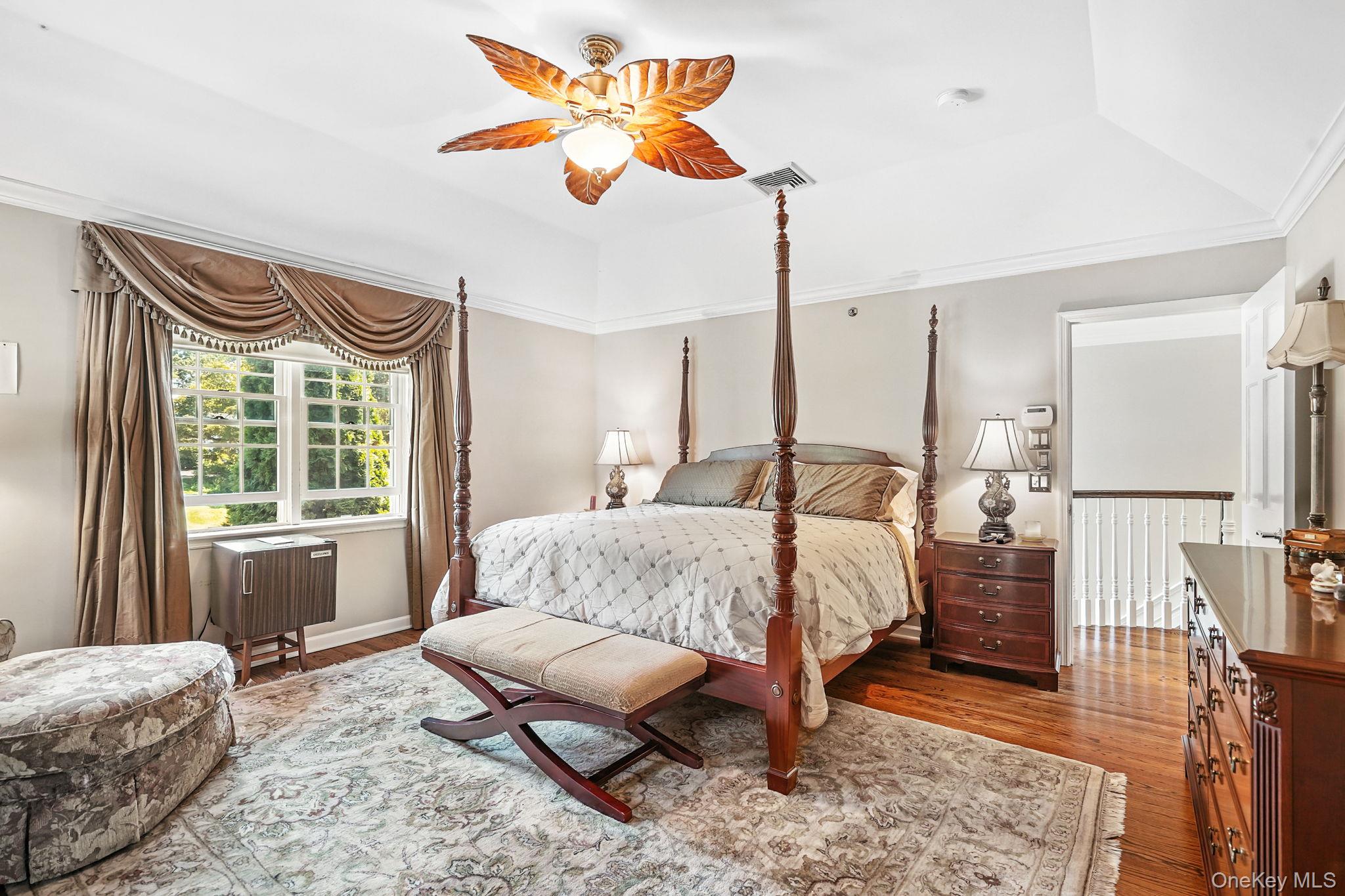 33 Hevelyne Road Elmsford, NY 10523 - Photo 26 of 43 Bedroom featuring wood finished floors, ornamental molding, a ceiling fan, and a raised ceiling