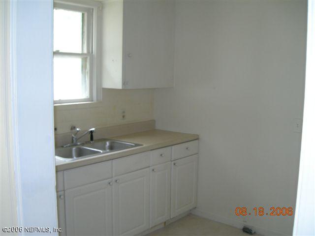 1840 Prospect Street Jacksonville, FL 32208 - Photo 5 of 9 a kitchen with a sink and cabinets