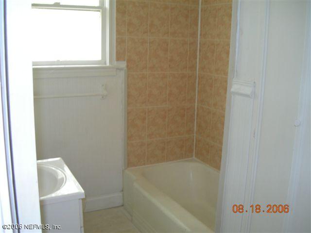 1840 Prospect Street Jacksonville, FL 32208 - Photo 6 of 9 a bath tub sitting next to a white sink and vanity