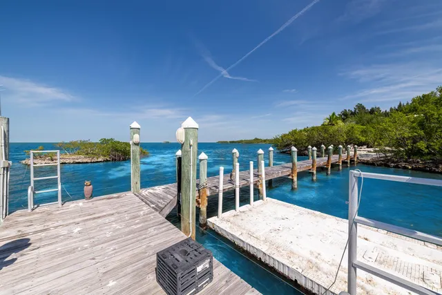 a living room with furniture and a book shelf