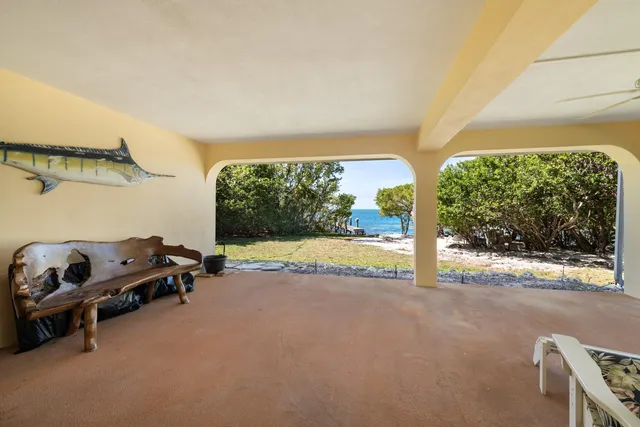 a living room with furniture a flat screen tv and a large window