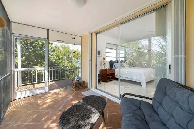 a kitchen with white cabinets appliances and a window