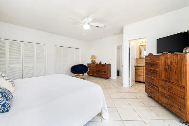 a view of a room with wooden floor and potted plants