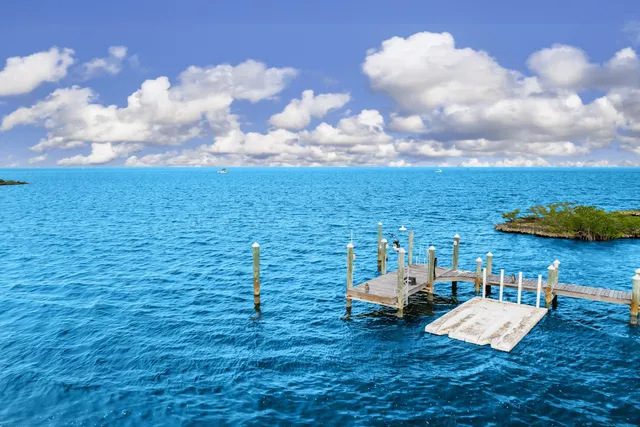 a living room with furniture a flat screen tv and a large window