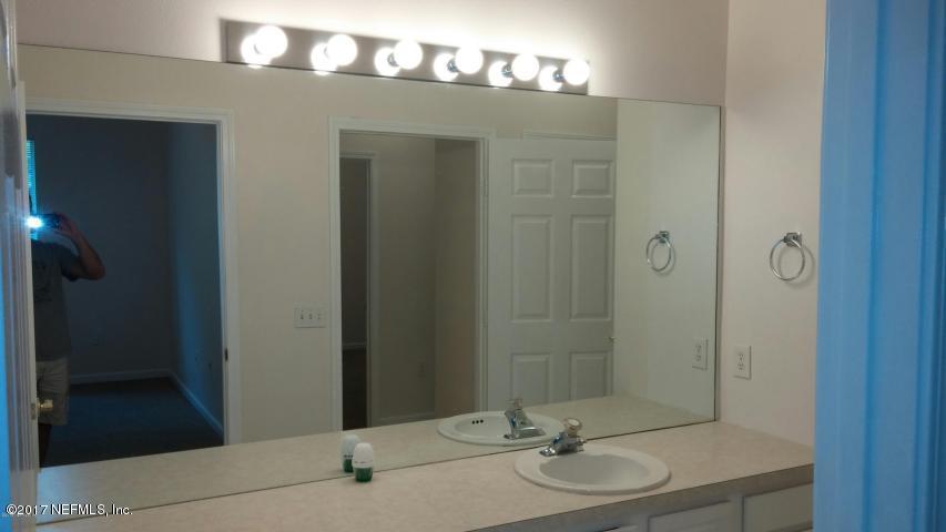 10550 Baymeadows Road, Unit 619 Jacksonville, FL 32256 - Photo 3 of 9 a bathroom with a sink and mirror