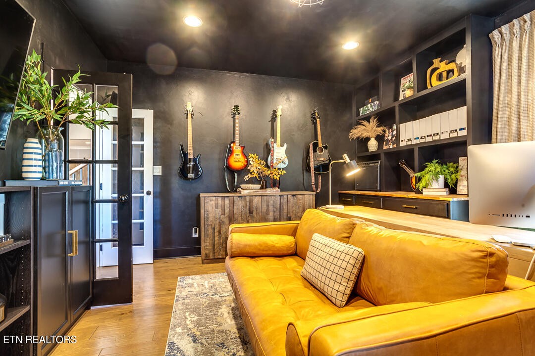 6015 Cate Road Powell, TN 37849 - Photo 12 of 60 a bedroom with a bed lamps and wooden floor