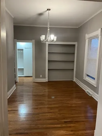 a view of a room with wooden floor and staircase