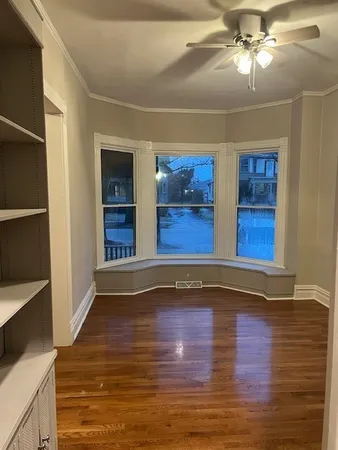 a view of room with hardwood floor and ceiling fan