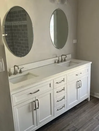 a bathroom with a double vanity sink and mirror