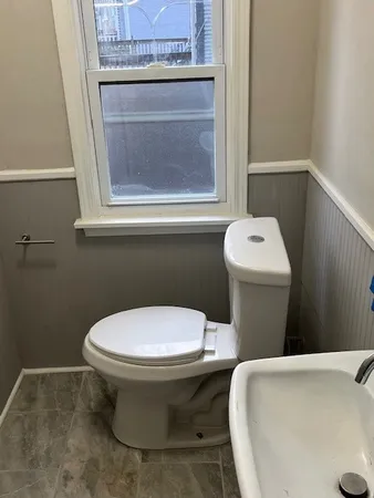 a white toilet sitting next to a bathroom sink