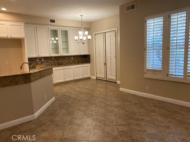 2522 Tequestra Tustin, CA 92782 - Photo 11 of 19 a large kitchen with kitchen island granite countertop a sink and cabinets