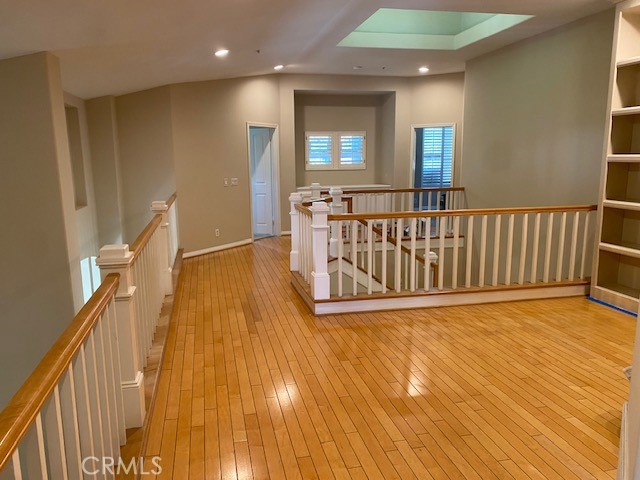 2522 Tequestra Tustin, CA 92782 - Photo 13 of 19 a view of a hallway with wooden floor and stairs
