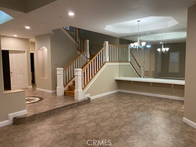 2522 Tequestra Tustin, CA 92782 - Photo 9 of 19 a view of a hallway with two chairs and a chandelier