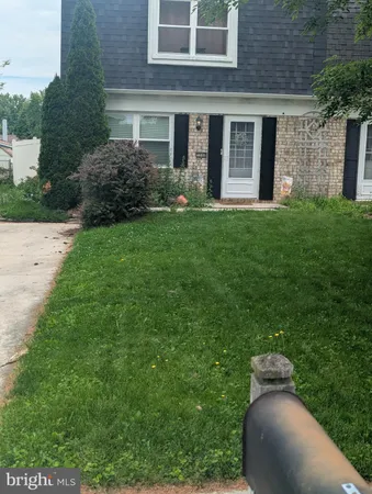 a front view of a house with garden and porch