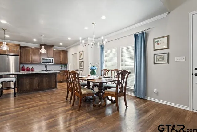 a view of a dining room with furniture and wooden floor