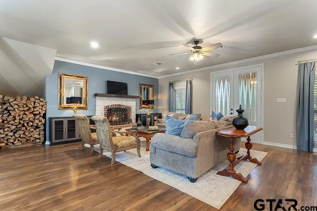 a living room with furniture a fireplace and a flat screen tv
