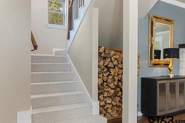 a view of staircase with white walls and a window