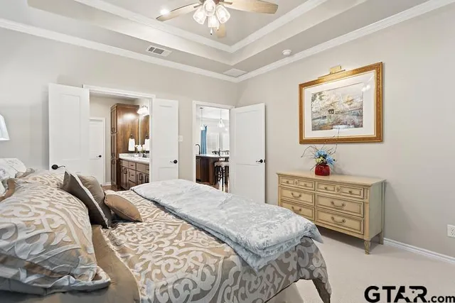 a bedroom with a bed and a chandelier