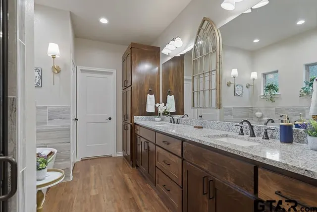 a bathroom with a double vanity sink and a mirror