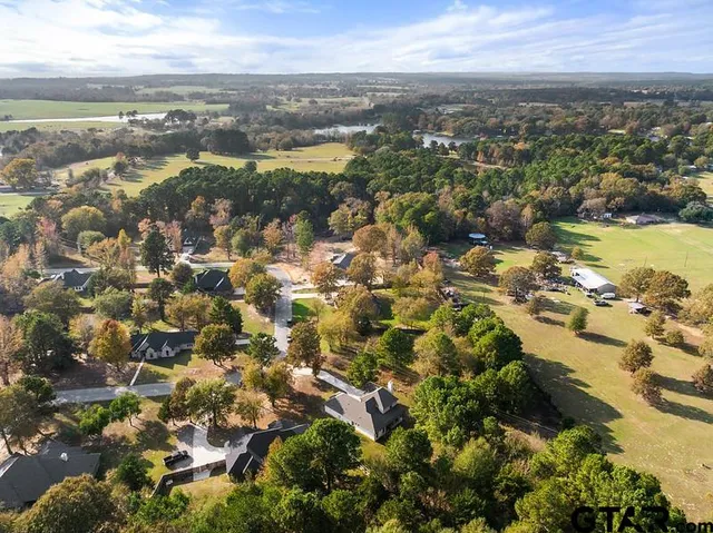 an aerial view of residential houses with outdoor space and swimming pool