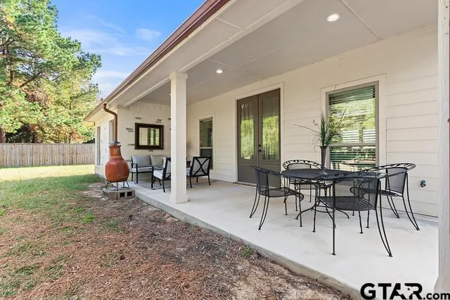 a patio with table and chairs