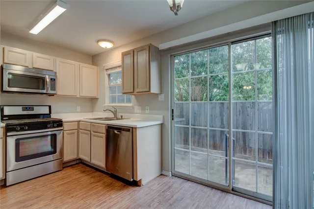 a kitchen with a sink stove and cabinets