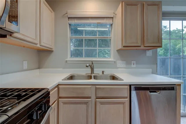 a kitchen with white cabinets and a sink