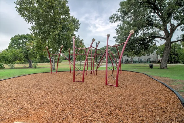 a view of outdoor space with playground and green space