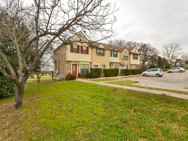 a front view of a building with a garden