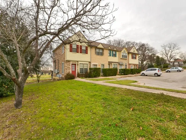 a front view of a building with a garden