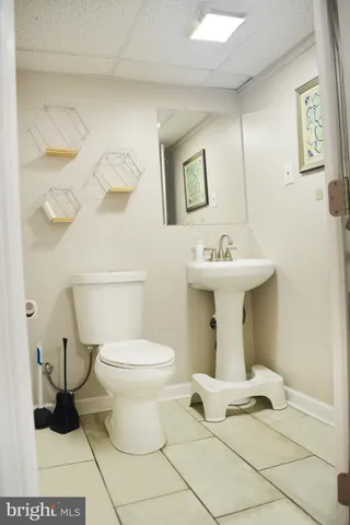 a bathroom with a sink toilet and a mirror