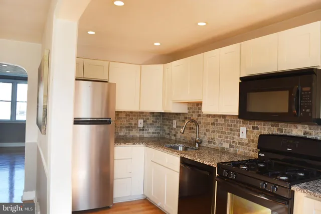 a kitchen with stainless steel appliances a refrigerator sink and stove