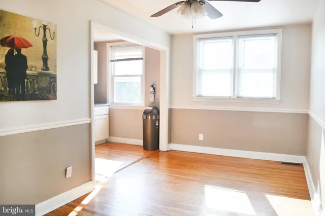 a view of a livingroom with wooden floor and a window