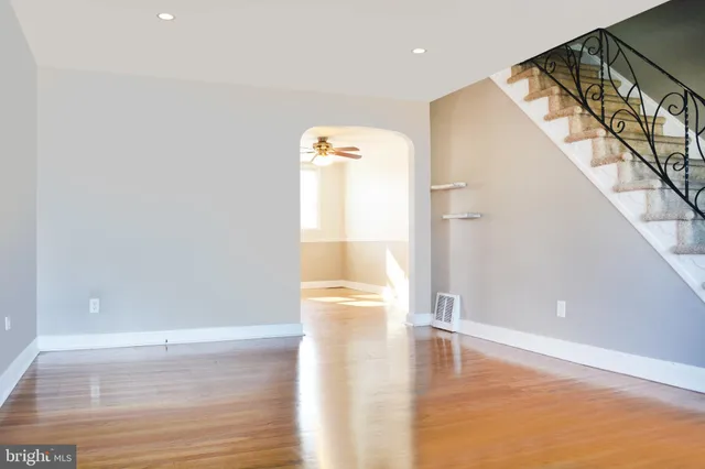 a view of empty room with wooden floor
