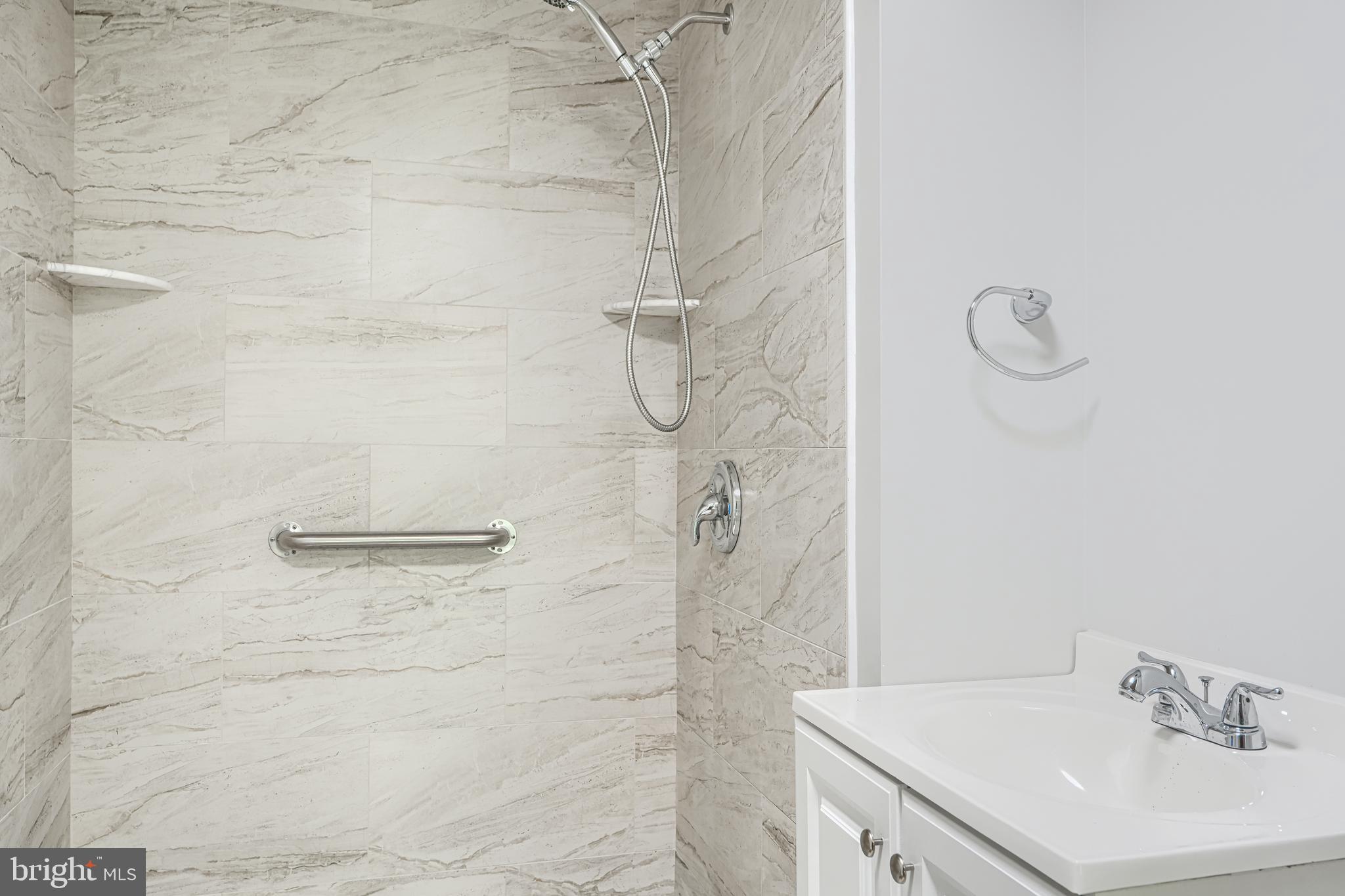 2 Romanoff Court Baltimore, MD 21234 - Photo 27 of 34 a bathroom with a sink a shower and vanity