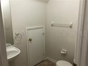 a bathroom with a granite countertop toilet a sink and shower